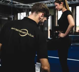 Trainer von PhysioSport Köln mit einer Sportlerin bei Koordinationstraining.