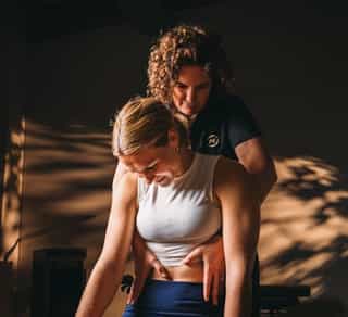 Physiotherapeutin von PhysioSport Köln behandelt eine Patientin mit Krankengymnastik auf neurologischer Basis im Bereich Oberkörper.